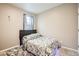 Cozy bedroom featuring a queen-sized bed, patterned bedding, and ambient under-lighting for a modern touch at 6711 Fraser Cir, Frederick, CO 80530