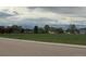 Spacious community green space surrounded by trees and houses in a suburban neighborhood at 6711 Fraser Cir, Frederick, CO 80530