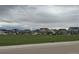 View of community green space surrounded by houses in a suburban neighborhood at 6711 Fraser Cir, Frederick, CO 80530