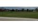 Community green space featuring a wooden bench surrounded by trees and houses at 6711 Fraser Cir, Frederick, CO 80530