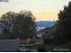 Home exterior at sunset featuring trees and blue skies at 6711 Fraser Cir, Frederick, CO 80530