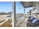Covered front porch with comfortable wicker seating and views of the street at 6711 Fraser Cir, Frederick, CO 80530