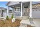 Inviting front porch with white columns and room for seating at 6711 Fraser Cir, Frederick, CO 80530