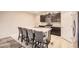 Well-lit kitchen area with stainless steel appliances, light countertops, and dark brown cabinets at 6711 Fraser Cir, Frederick, CO 80530