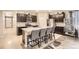 Open kitchen featuring dark cabinetry, stainless steel appliances and a large island at 6711 Fraser Cir, Frederick, CO 80530
