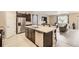 Bright kitchen area with dark cabinets, stainless steel appliances and an island at 6711 Fraser Cir, Frederick, CO 80530