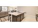 Stylish kitchen island featuring barstool seating, stainless steel sink, and plenty of storage space at 6711 Fraser Cir, Frederick, CO 80530