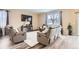 Comfortable living room area with a fireplace, tv, and comfortable leather furnishings at 6711 Fraser Cir, Frederick, CO 80530