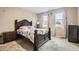 Comfortable main bedroom showcasing a beautiful wooden bed frame and natural lighting at 6711 Fraser Cir, Frederick, CO 80530