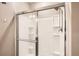 Shower with sliding glass doors and built-in shelving at 6711 Fraser Cir, Frederick, CO 80530