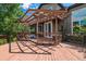 Large backyard wooden deck with pergola, decorative railing, and french doors to inside at 10358 Kelliwood Way, Highlands Ranch, CO 80126