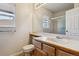 Bright bathroom with a single sink vanity, large mirror, and a glass-enclosed shower at 10358 Kelliwood Way, Highlands Ranch, CO 80126