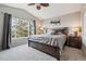 Comfortable bedroom with a ceiling fan, bedside tables, and a large window at 10358 Kelliwood Way, Highlands Ranch, CO 80126