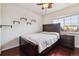 Cozy bedroom with a ceiling fan, hardwood floors, and built in shelves at 10358 Kelliwood Way, Highlands Ranch, CO 80126