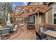 Back deck with barbeque, dining table and chairs, and wood pergola at 10358 Kelliwood Way, Highlands Ranch, CO 80126