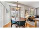 Cozy dining area with hardwood floors, modern chandelier, and access to the backyard at 10358 Kelliwood Way, Highlands Ranch, CO 80126