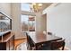 Dining area with large windows and dark wood table at 10358 Kelliwood Way, Highlands Ranch, CO 80126