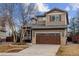 Charming two-story home featuring a well-maintained front yard and attached two-car garage at 10358 Kelliwood Way, Highlands Ranch, CO 80126