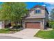 Charming two-story home featuring well-maintained landscaping, a two-car garage and a beautiful tree in the front yard at 10358 Kelliwood Way, Highlands Ranch, CO 80126