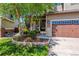 Charming two-story home featuring well-maintained landscaping, a two-car garage and a beautiful tree in the front yard at 10358 Kelliwood Way, Highlands Ranch, CO 80126