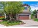 Charming two-story home featuring well-maintained landscaping, a two-car garage and a beautiful tree in the front yard at 10358 Kelliwood Way, Highlands Ranch, CO 80126