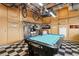 Garage featuring checkerboard flooring, slatwall, overhead storage, and a pool table at 10358 Kelliwood Way, Highlands Ranch, CO 80126