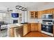 Well-lit kitchen featuring light-colored cabinets, a modern stove, and stainless steel appliances at 10358 Kelliwood Way, Highlands Ranch, CO 80126