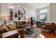 Open-concept living room with high ceilings, stained glass windows, and hardwood floors at 10358 Kelliwood Way, Highlands Ranch, CO 80126