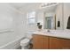 Bright bathroom with a tiled shower-tub and an ample sized vanity at 4865 Gibraltar St, Denver, CO 80249