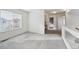 Bright hallway featuring neutral colors, large window, and access to multiple rooms at 4865 Gibraltar St, Denver, CO 80249