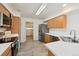 Functional kitchen featuring stainless steel appliances, tile floors, and ample cabinet space, blending convenience with practicality at 4865 Gibraltar St, Denver, CO 80249