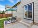 Backyard patio with outdoor furniture, sliding glass door entrance, and green grass at 718 Fairhaven St, Castle Rock, CO 80104