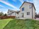 A spacious backyard features a lush green lawn, patio set, and privacy fence for outdoor living and entertaining at 718 Fairhaven St, Castle Rock, CO 80104