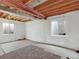 Spacious unfinished basement with concrete floor, two windows, and exposed ceiling beams at 718 Fairhaven St, Castle Rock, CO 80104