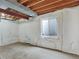 Unfinished basement, showing wrap, beams, concrete slab and a window at 718 Fairhaven St, Castle Rock, CO 80104