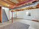 Unfinished basement with exposed ceiling and beams, a carpet remnant, and a small window at 718 Fairhaven St, Castle Rock, CO 80104