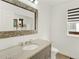 Bathroom with granite countertop, decorative mirror, and updated fixtures giving a fresh look at 718 Fairhaven St, Castle Rock, CO 80104