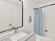 Bathroom featuring a blue-striped shower curtain and marble countertop at 718 Fairhaven St, Castle Rock, CO 80104
