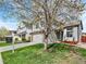 Attractive home boasts a well-kept lawn, brick accents, two-car garage and welcoming front entrance at 718 Fairhaven St, Castle Rock, CO 80104