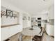 Bright kitchen with white cabinets, stainless steel appliances, and a dining area for a warm and inviting atmosphere at 718 Fairhaven St, Castle Rock, CO 80104