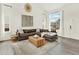 Inviting living room featuring a leather sectional, large window, vaulted ceiling, and neutral decor at 718 Fairhaven St, Castle Rock, CO 80104