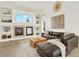 Bright living room with a fireplace, built-in shelving, and a comfortable leather sectional sofa at 718 Fairhaven St, Castle Rock, CO 80104