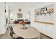 Spacious living room with a large brown couch, dining table, and ample natural light for a comfortable gathering place at 718 Fairhaven St, Castle Rock, CO 80104