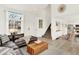 Spacious living room with a leather sectional, large windows, staircase, and open-concept design at 718 Fairhaven St, Castle Rock, CO 80104