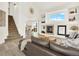 Bright living room with stairs, fireplace, and an open floorplan offering a cozy yet modern atmosphere at 718 Fairhaven St, Castle Rock, CO 80104