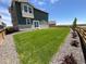 A beautifully maintained backyard with a lush green lawn, perfect for outdoor enjoyment at 12892 E 99Th Pl, Commerce City, CO 80022