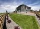 Spacious backyard featuring lush green grass and well manicured landscaping at 12892 E 99Th Pl, Commerce City, CO 80022