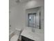 Clean bathroom with a large mirror and bathtub shower at 12892 E 99Th Pl, Commerce City, CO 80022