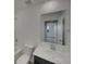 The bathroom is well lit and features white countertops and tile at 12892 E 99Th Pl, Commerce City, CO 80022