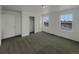 Bright bedroom with carpet, closet, and two large windows bringing in natural light at 12892 E 99Th Pl, Commerce City, CO 80022